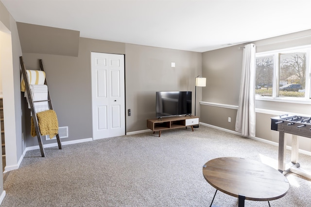 living room featuring carpet flooring, visible vents, and baseboards