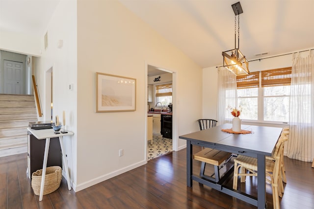 dining room featuring dark wood-style flooring, stairway, visible vents, and vaulted ceiling