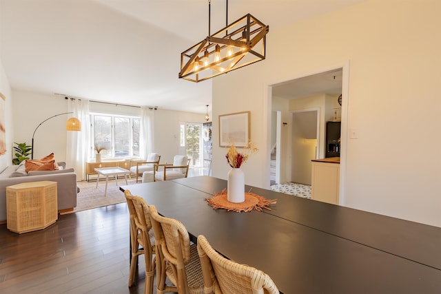 dining space with dark wood-style floors and stairs