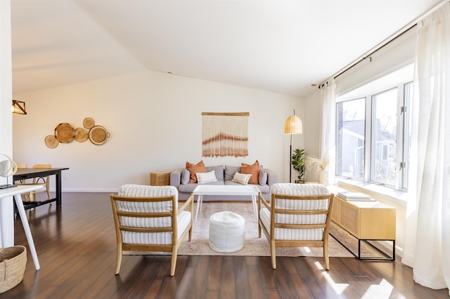 living room featuring vaulted ceiling, baseboards, and dark wood-type flooring