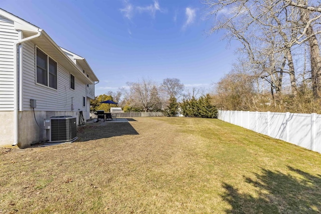 view of yard with a patio area, central air condition unit, and a fenced backyard