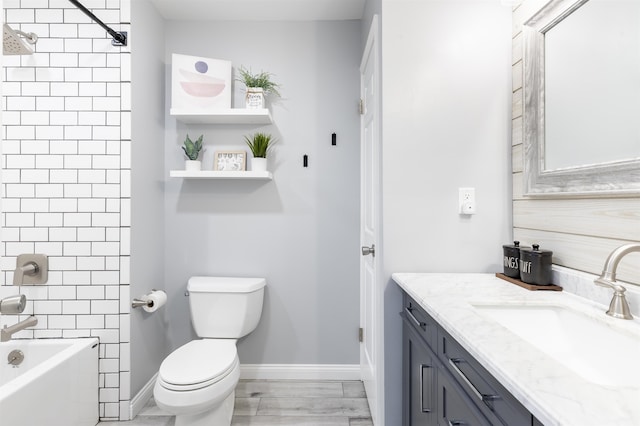 full bath with vanity, toilet, shower / bath combination, and baseboards