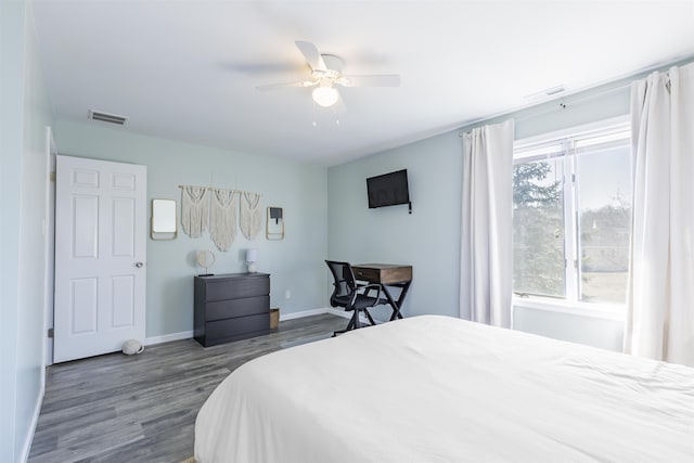 bedroom with dark wood finished floors, visible vents, ceiling fan, and baseboards