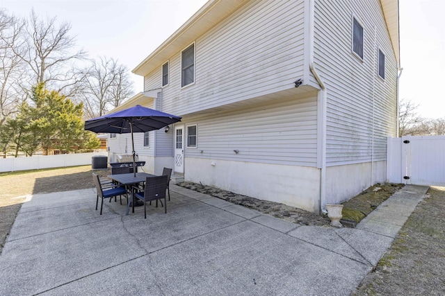 exterior space featuring central air condition unit and fence