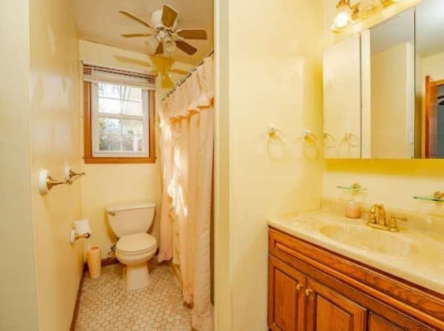 bathroom with vanity, ceiling fan, curtained shower, and toilet