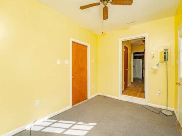 unfurnished bedroom with ceiling fan and carpet floors