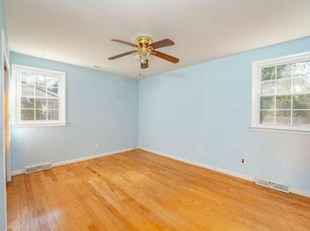 empty room with hardwood / wood-style flooring and ceiling fan