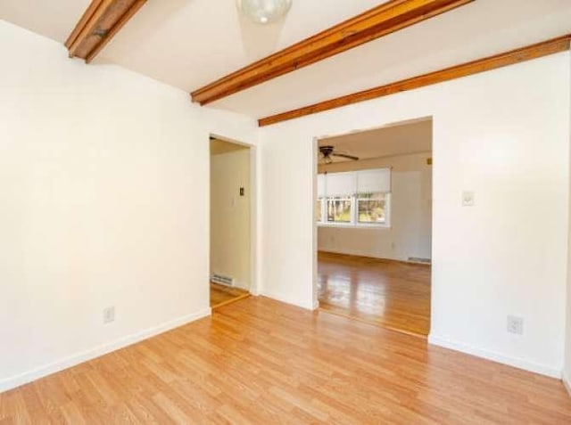 spare room with beamed ceiling, ceiling fan, and light hardwood / wood-style flooring