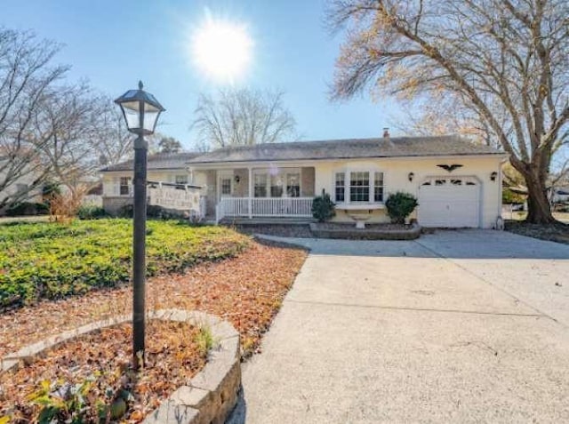 single story home featuring a garage and covered porch