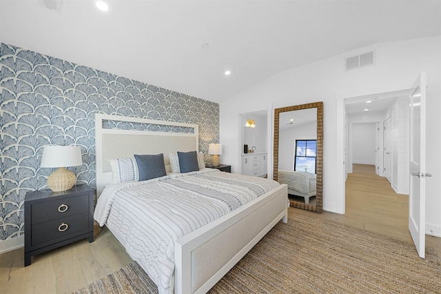 bedroom with light hardwood / wood-style floors and vaulted ceiling