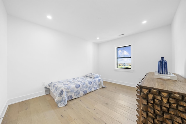 bedroom with hardwood / wood-style flooring