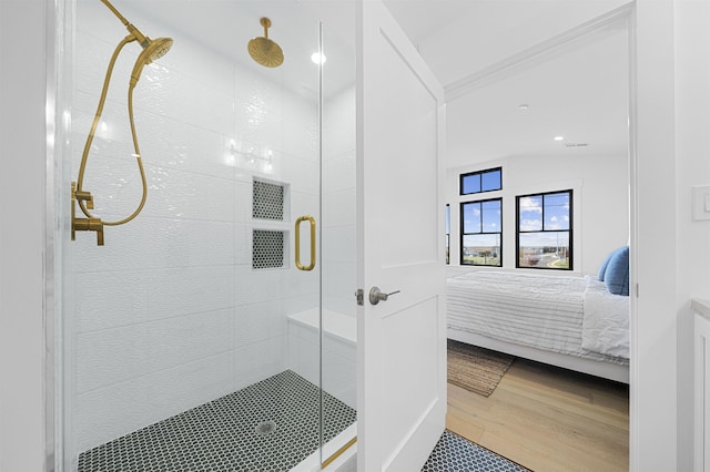 bathroom featuring hardwood / wood-style flooring, lofted ceiling, and a shower with door