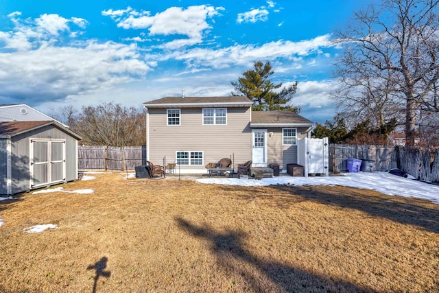 back of property with a storage shed, a yard, a patio, and an outdoor fire pit