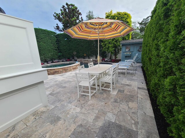 128 30th St, Avalon, NJ 08202 - view of patio featuring outdoor dining space, a hot tub, and a storage unit