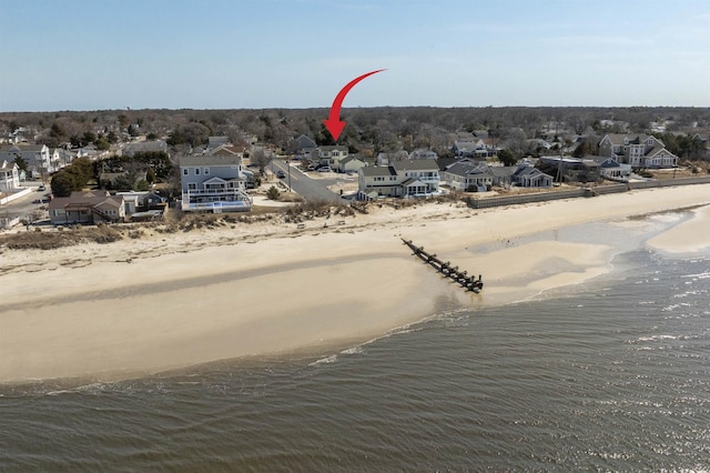 aerial view with a residential view, a view of the beach, and a water view