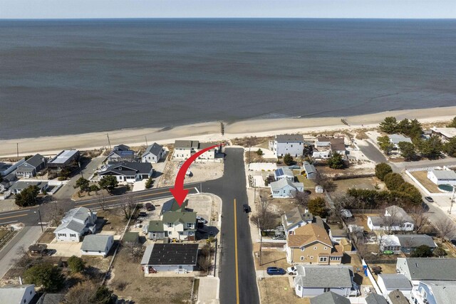 birds eye view of property with a residential view, a view of the beach, and a water view