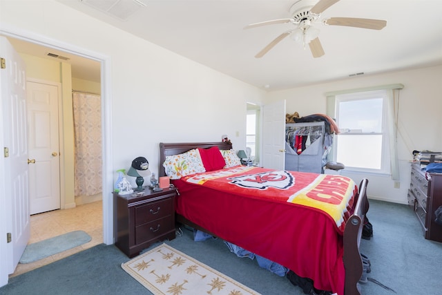 carpeted bedroom featuring visible vents and ceiling fan