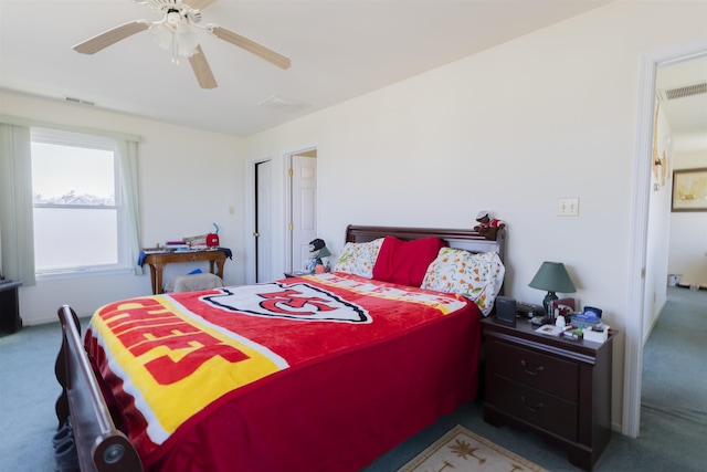 carpeted bedroom featuring a ceiling fan and visible vents