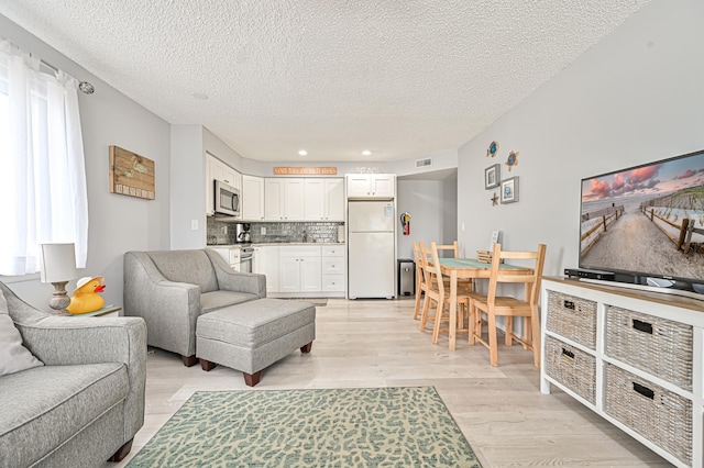 5301 Atlantic Ave Unit J, Wildwood, NJ 08260 - living area with light wood finished floors, a textured ceiling, and recessed lighting