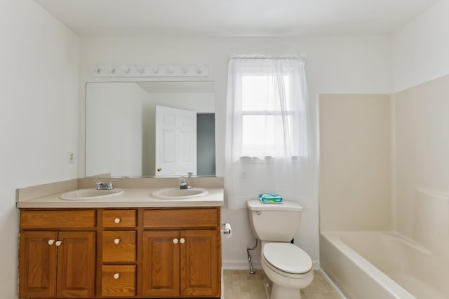 full bathroom featuring double vanity, toilet, a washtub, and a sink