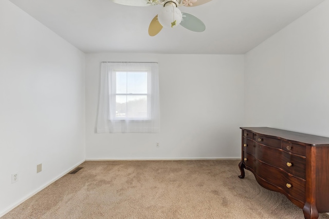 spare room featuring visible vents, baseboards, a ceiling fan, and carpet floors