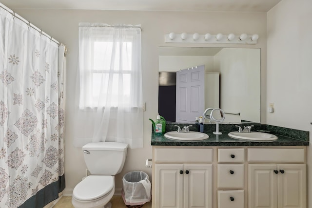 bathroom featuring a sink, curtained shower, toilet, and double vanity