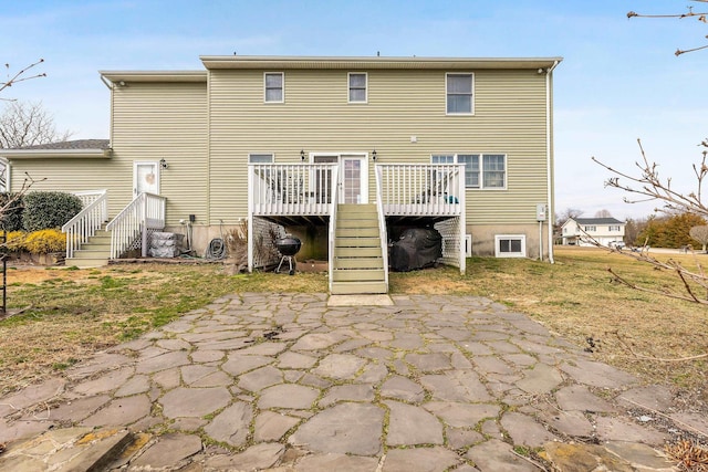 back of house featuring a deck and a patio area