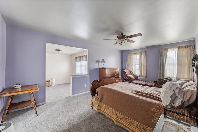 carpeted bedroom featuring baseboards and ceiling fan