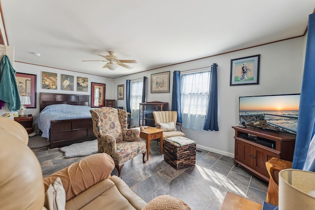 bedroom featuring baseboards, a ceiling fan, and stone finish floor