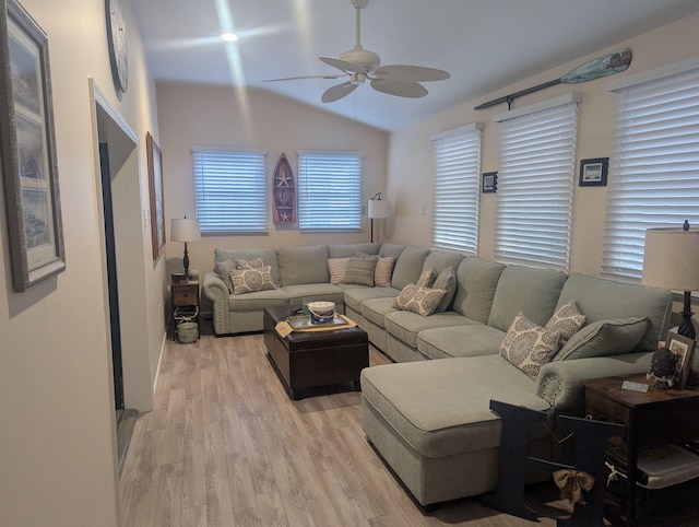 living room with ceiling fan, lofted ceiling, and light wood-type flooring