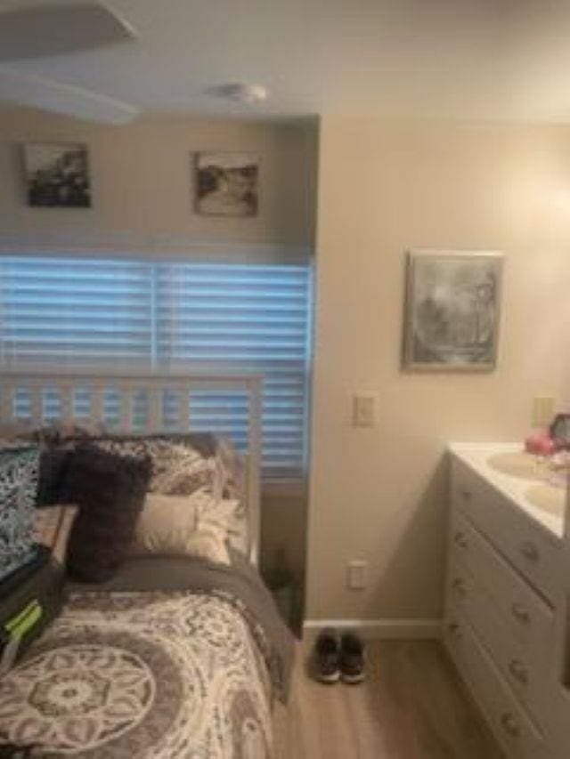 bedroom featuring hardwood / wood-style flooring and sink