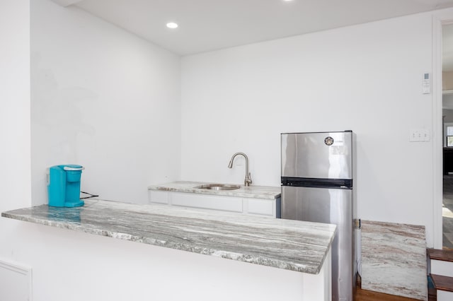 3108 Hemlock Rd, North Cape May, NJ 08204 - kitchen with freestanding refrigerator, a peninsula, white cabinetry, light stone countertops, and recessed lighting