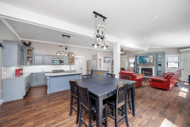 3108 Hemlock Rd, North Cape May, NJ 08204 - dining space featuring dark wood-style flooring, a fireplace, a ceiling fan, and beam ceiling