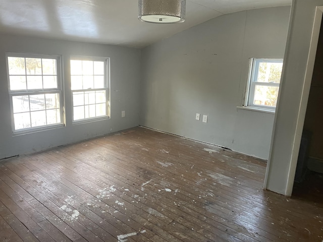 unfurnished dining area with vaulted ceiling, dark hardwood / wood-style flooring, and a wealth of natural light