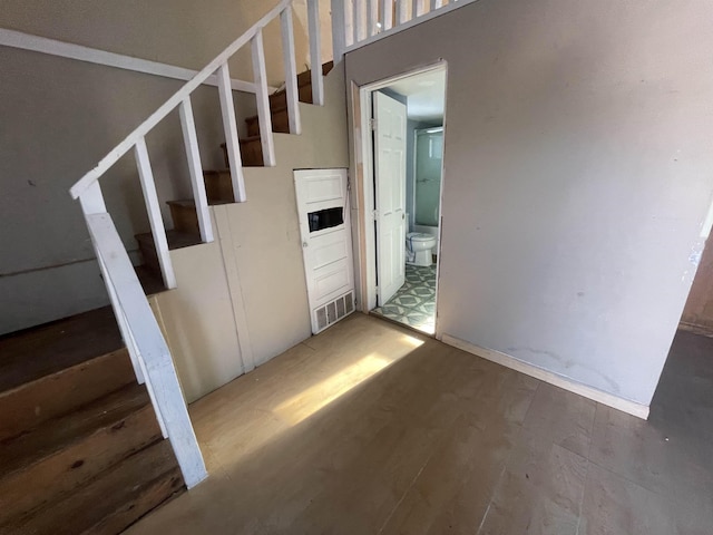 stairway featuring wood-type flooring