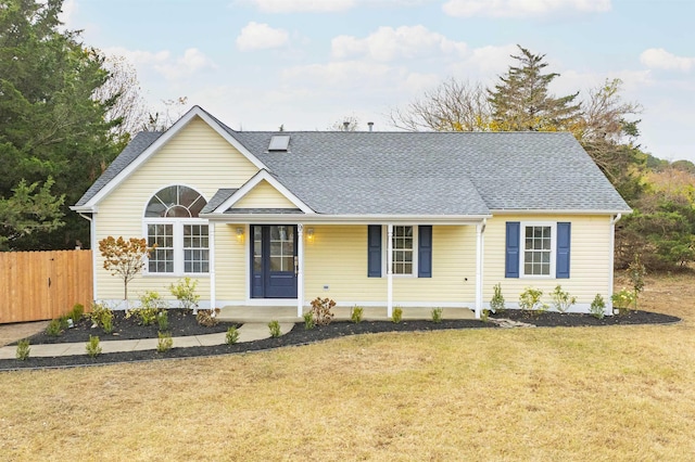 single story home with covered porch and a front yard