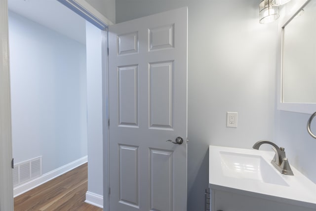 bathroom featuring vanity and wood-type flooring