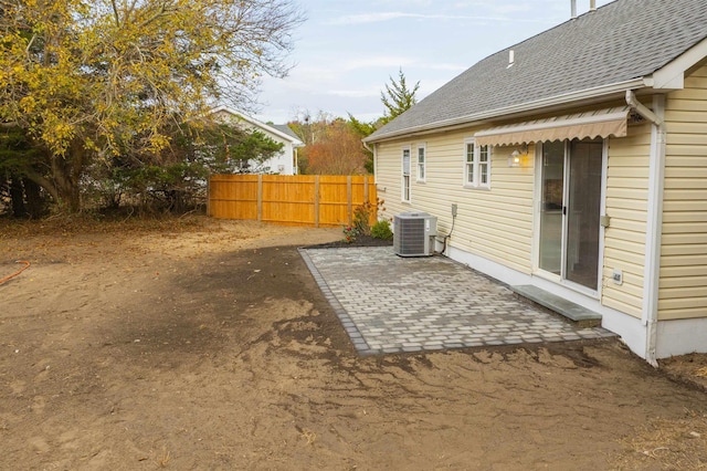 view of yard with cooling unit and a patio