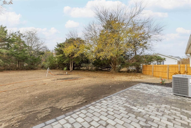 view of yard featuring cooling unit and a patio area