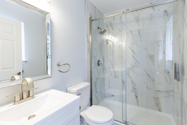 bathroom with vanity, a shower with shower door, and toilet