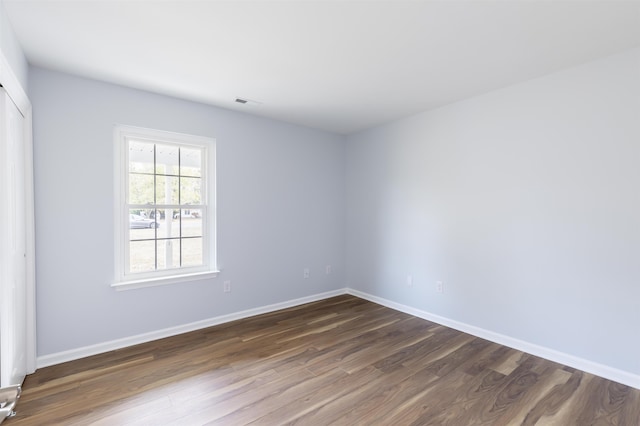 spare room featuring dark hardwood / wood-style floors