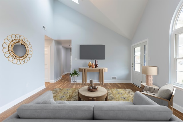 living room featuring high vaulted ceiling and hardwood / wood-style flooring