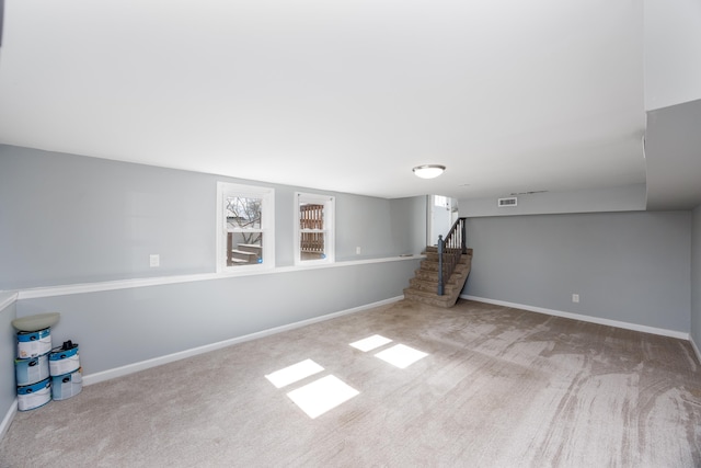 basement with stairs, carpet floors, and baseboards