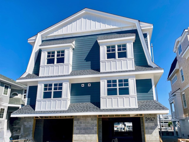 2425 Harbor Ave Unit 2425, Avalon, NJ 08202 - view of front facade featuring roof with shingles, a garage, and board and batten siding