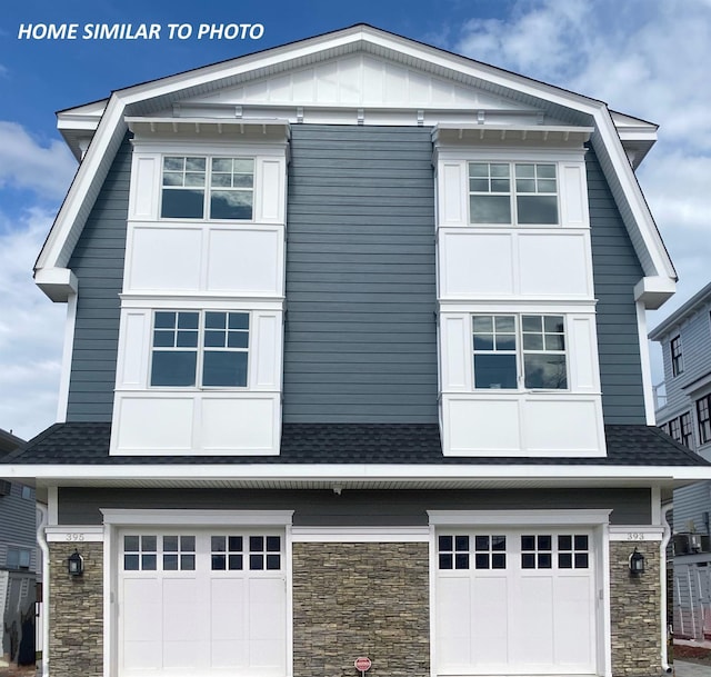 2425 Harbor Ave Unit 2425, Avalon, NJ 08202 - view of front facade with a garage, stone siding, and a shingled roof
