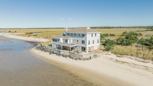 birds eye view of property featuring a water view, a rural view, and a view of the beach