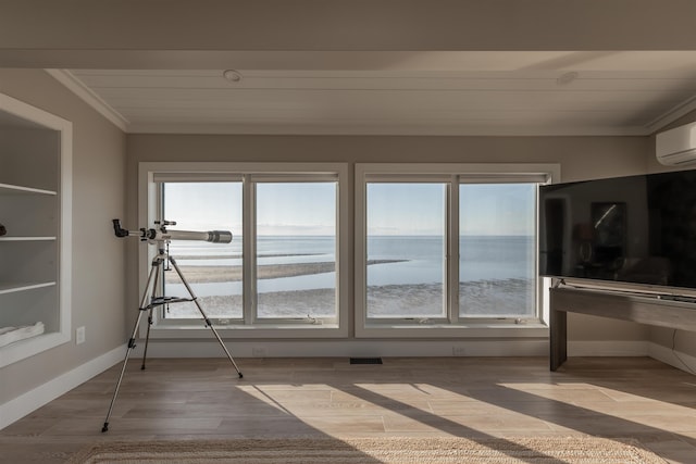 unfurnished sunroom with an AC wall unit, plenty of natural light, and wood ceiling