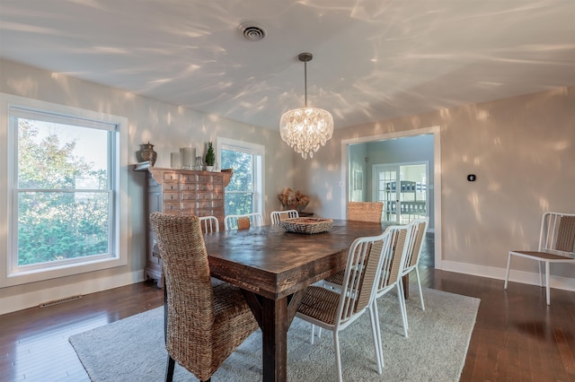 dining room featuring a wealth of natural light, a chandelier, and dark hardwood / wood-style floors