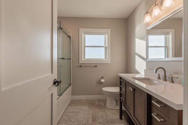 full bathroom featuring tile patterned floors, vanity, a healthy amount of sunlight, and toilet