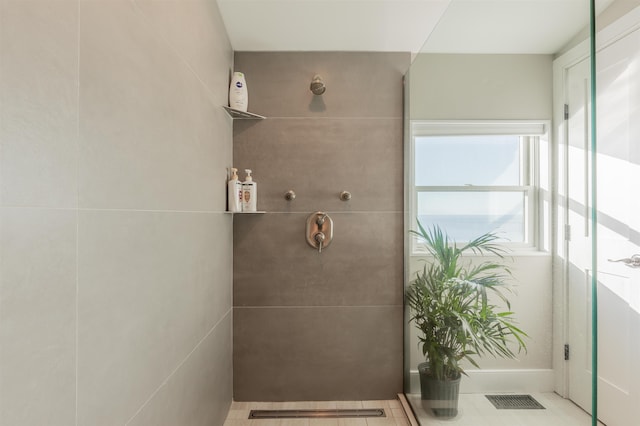 bathroom with tile patterned floors and a shower